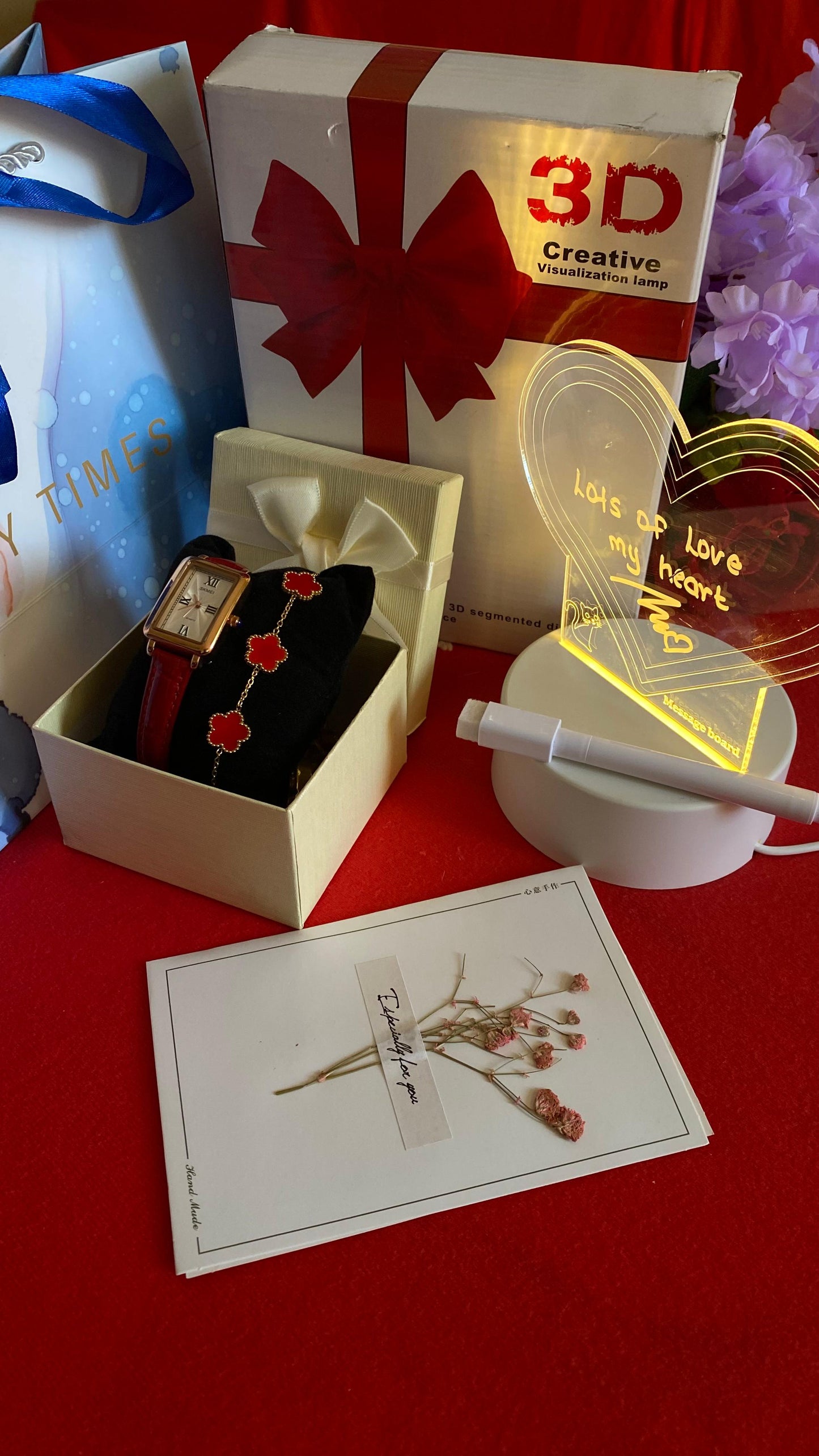 Collection of items including watch and card