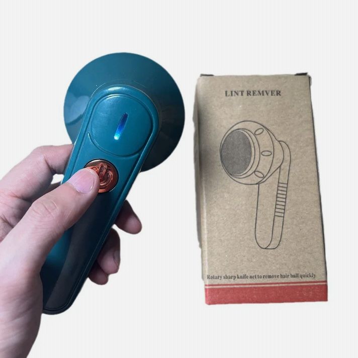 Hand holding a blue lint Remover