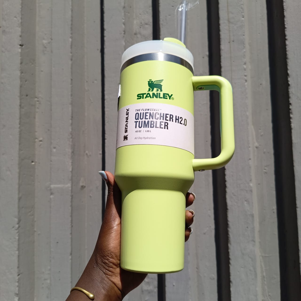 Hand holding green stanley 
