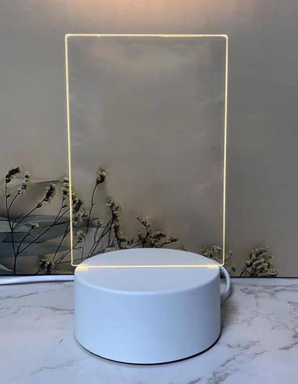 Neon sign with a rectangular frame on a white surface 