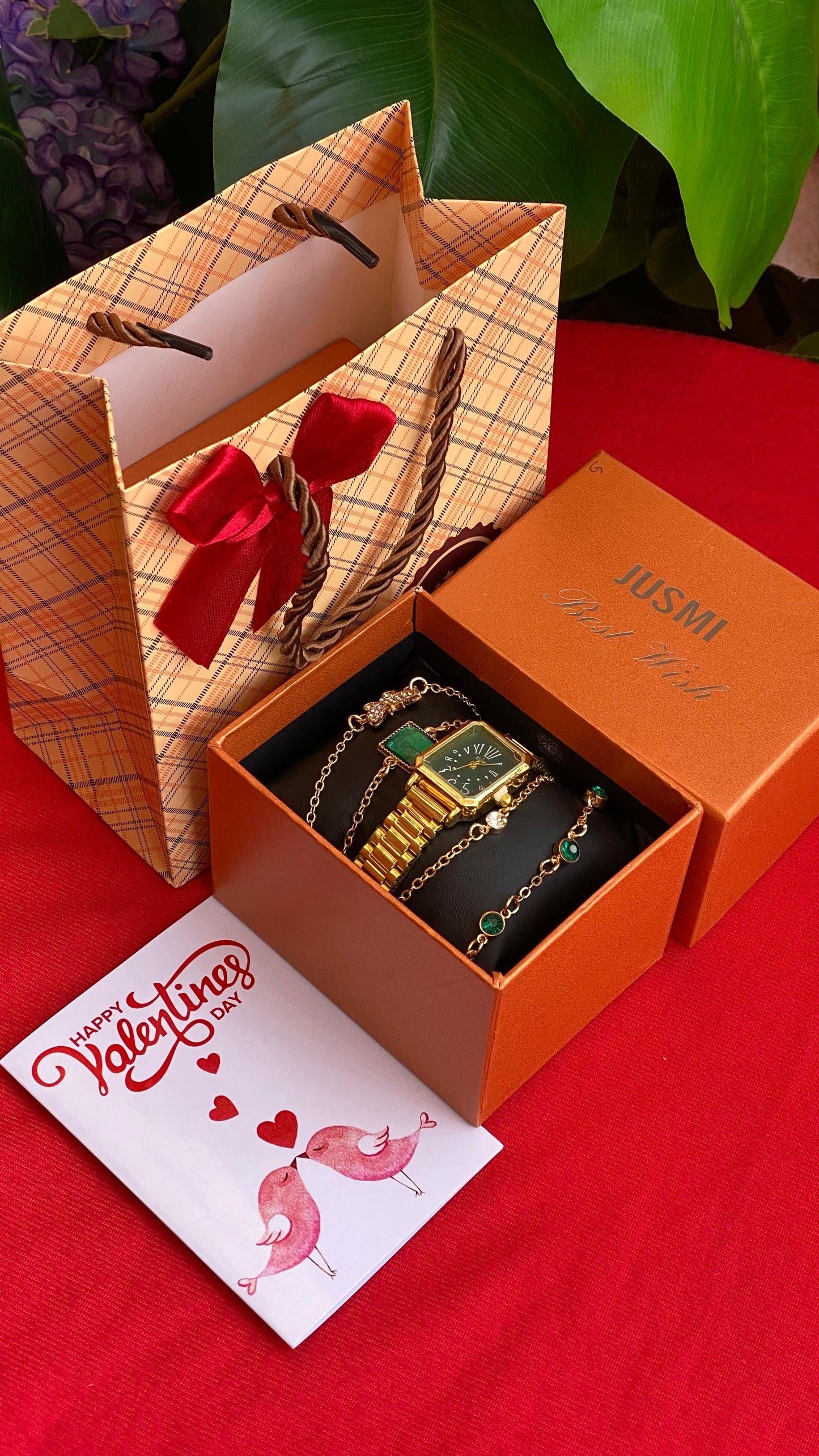 Orange jewelry box with gold watch and bracelet 